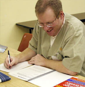 Happy inmate doing Criminon course