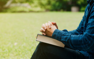 Young man sitting with a book