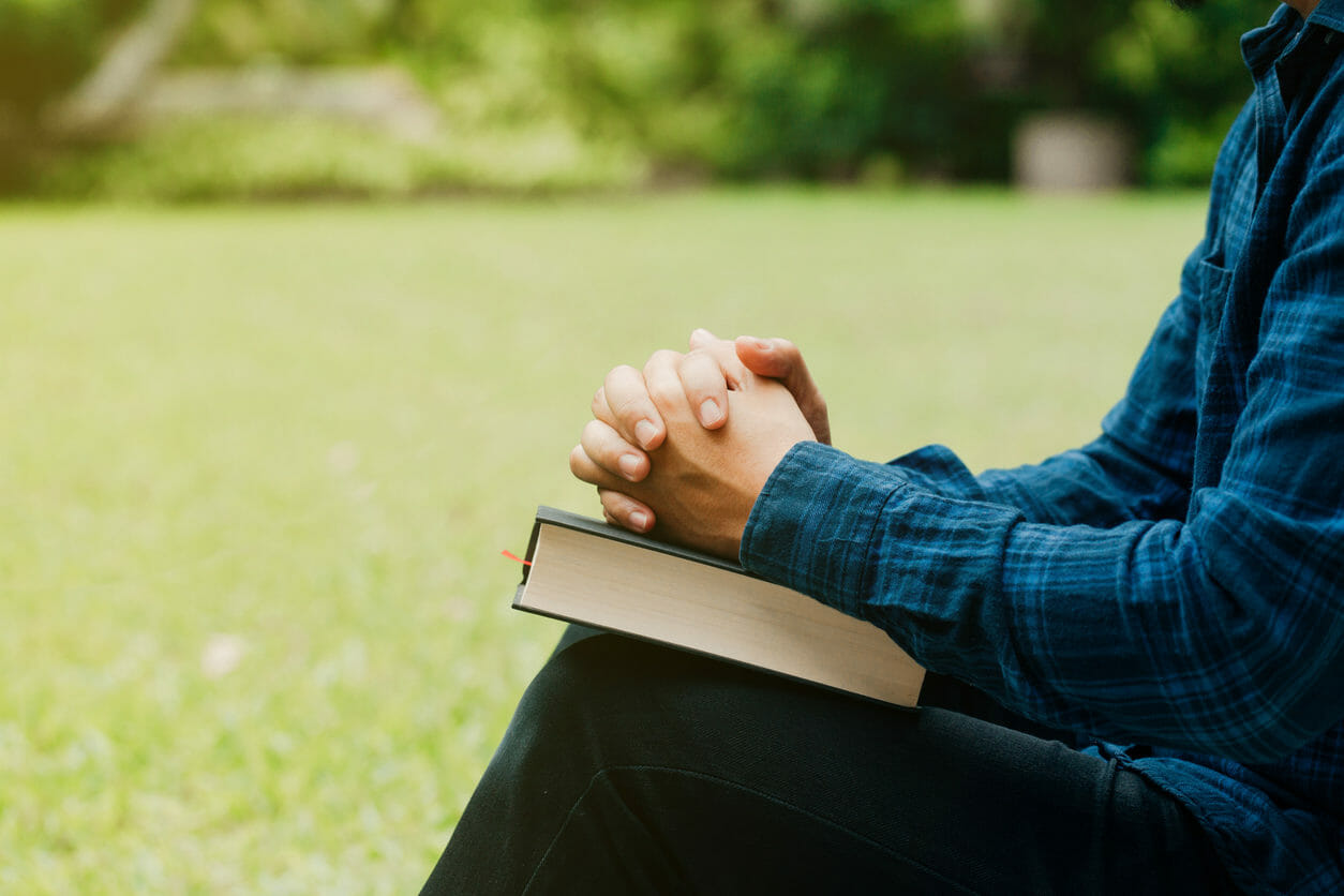 Young man sitting with a book