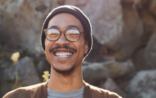 Young man smiling while enjoying a sunny day