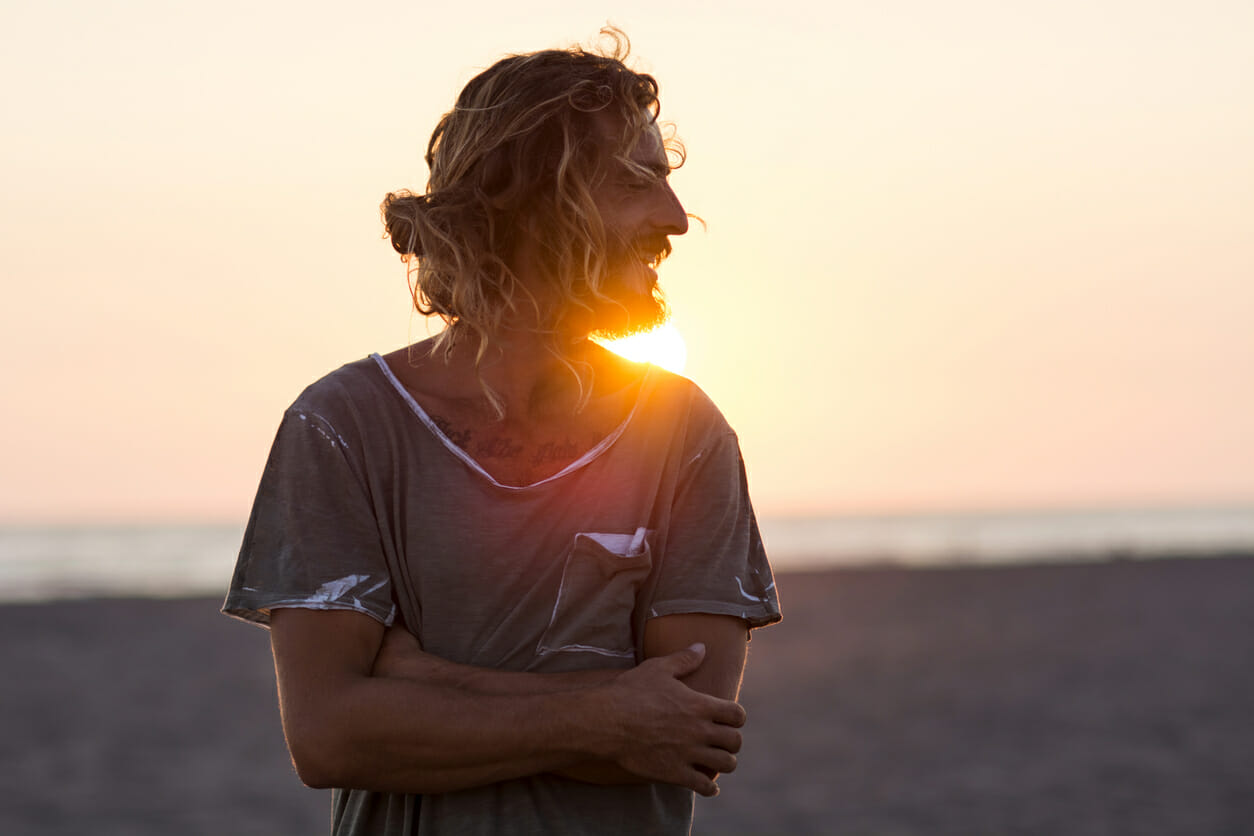 Portrait of young bearded man at the beach