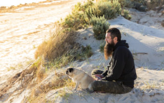 Happy Australian man at the bitch with his pug.