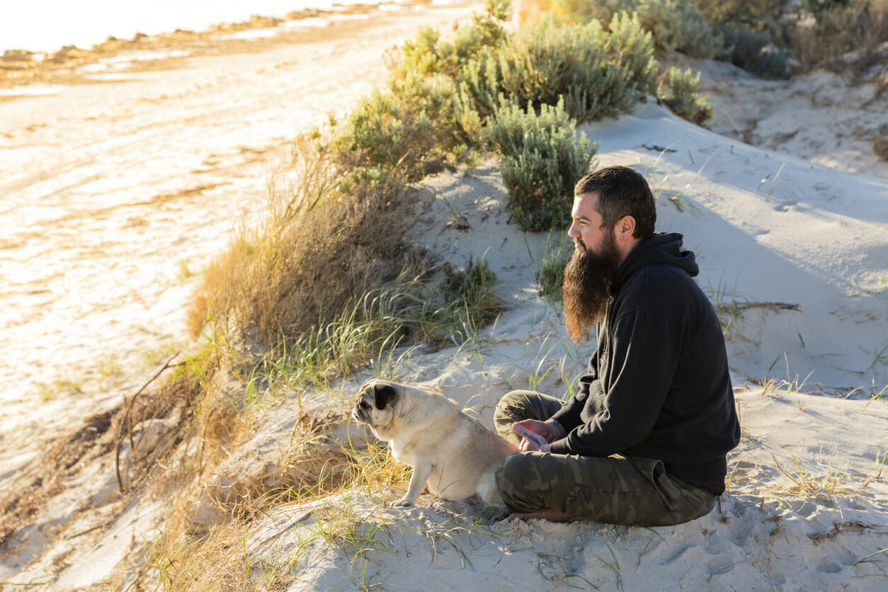 Happy Australian man at the bitch with his pug.