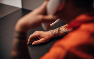 Male prisoner talking on phone in prison visit room