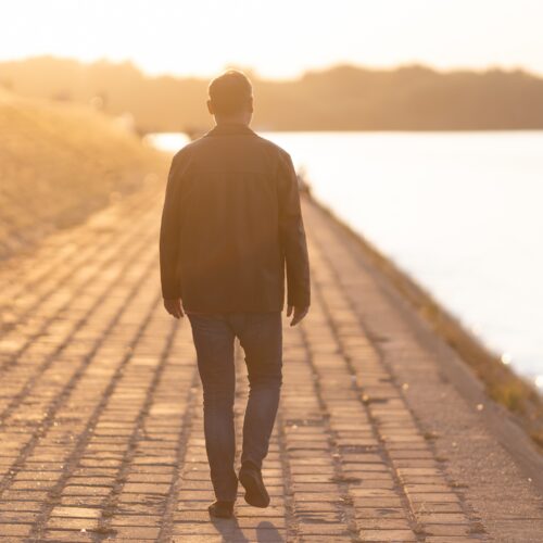 Happy man is walking outside