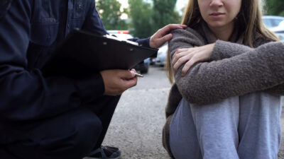 Police officer is talking to a woman victim