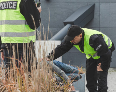 Police checking an addict on the street