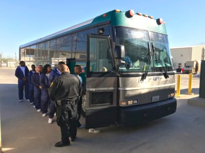 Inmates are getting on a private prison bus