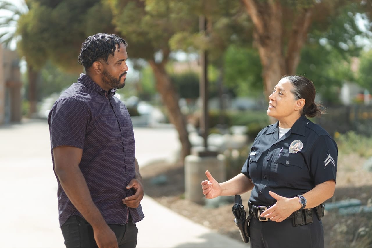 Policewoman talks to a man