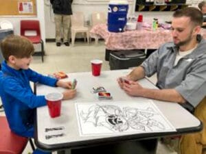 Inmate plays with his son.