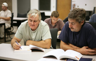 Adult men learning new skills for a job