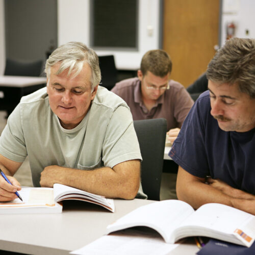 Adult men learning new skills for a job