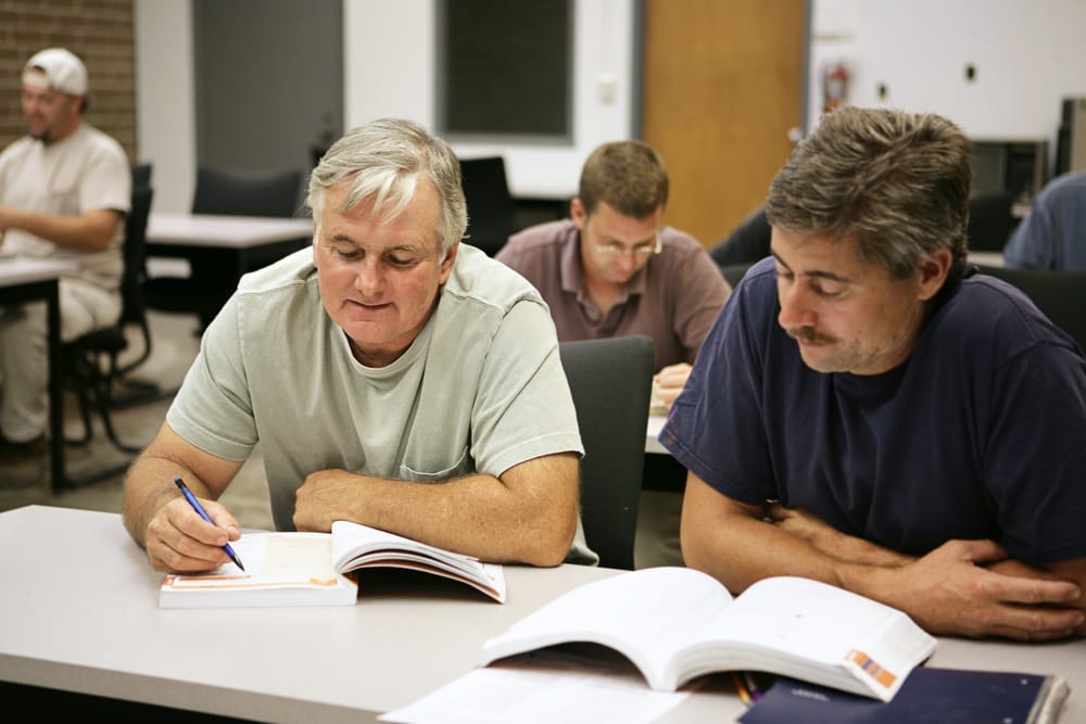 Adult men learning new skills for a job