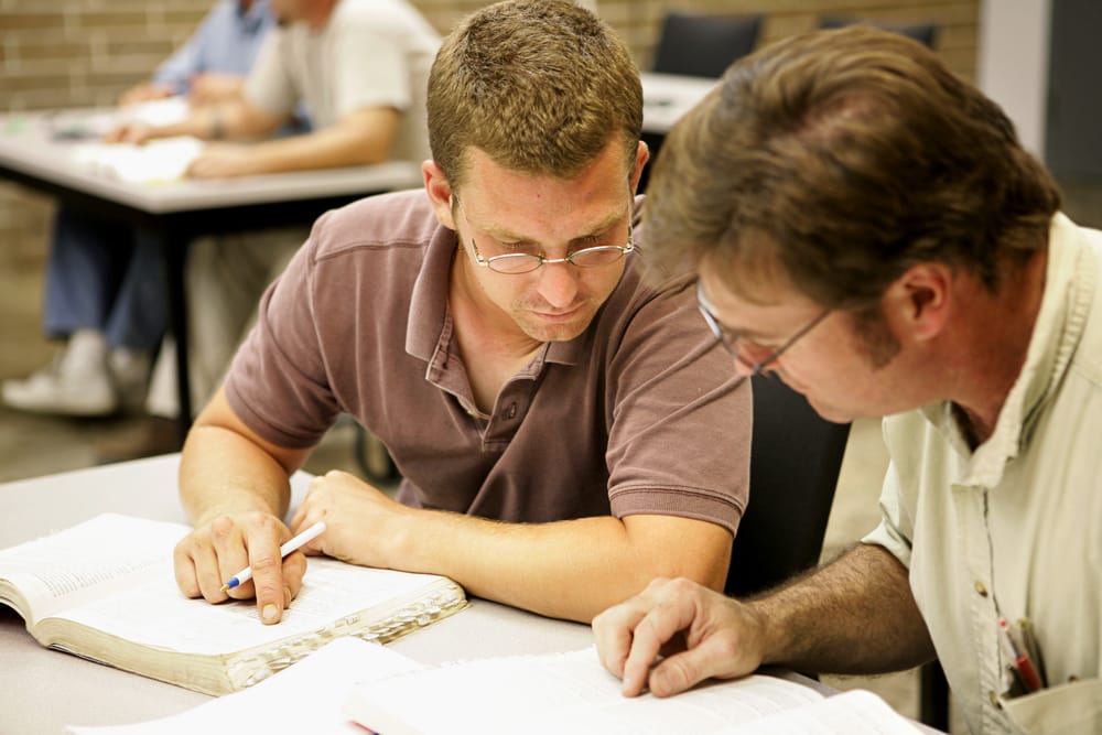 Adult men studying