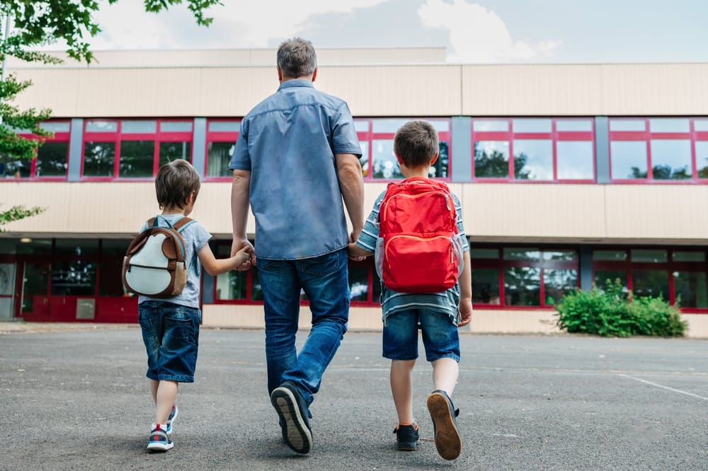 Man takes his boys to school